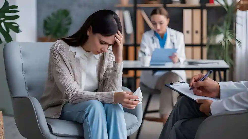 A woman looks down pensively during one-on-one psychotherapy in Tampa, FL