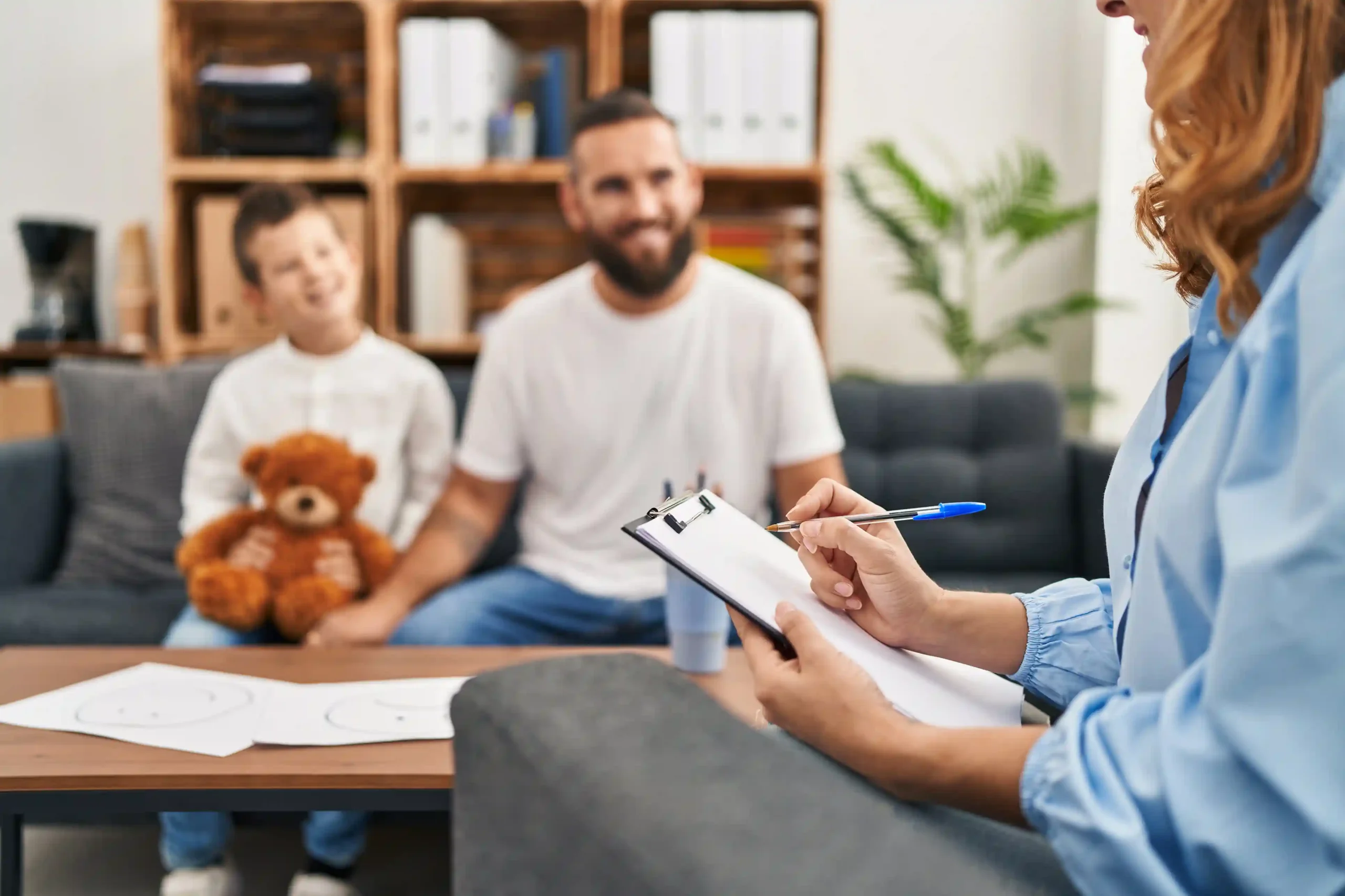 A father and young son participate in a family therapy session