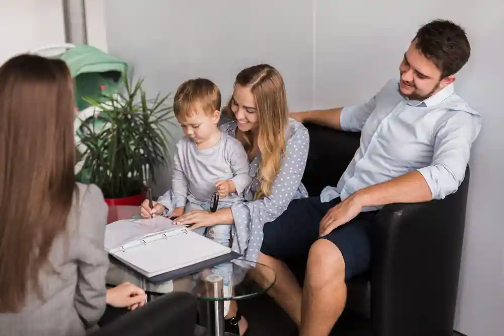 Happy family with a young boy engages in a supportive co-parenting therapy session in Tampa