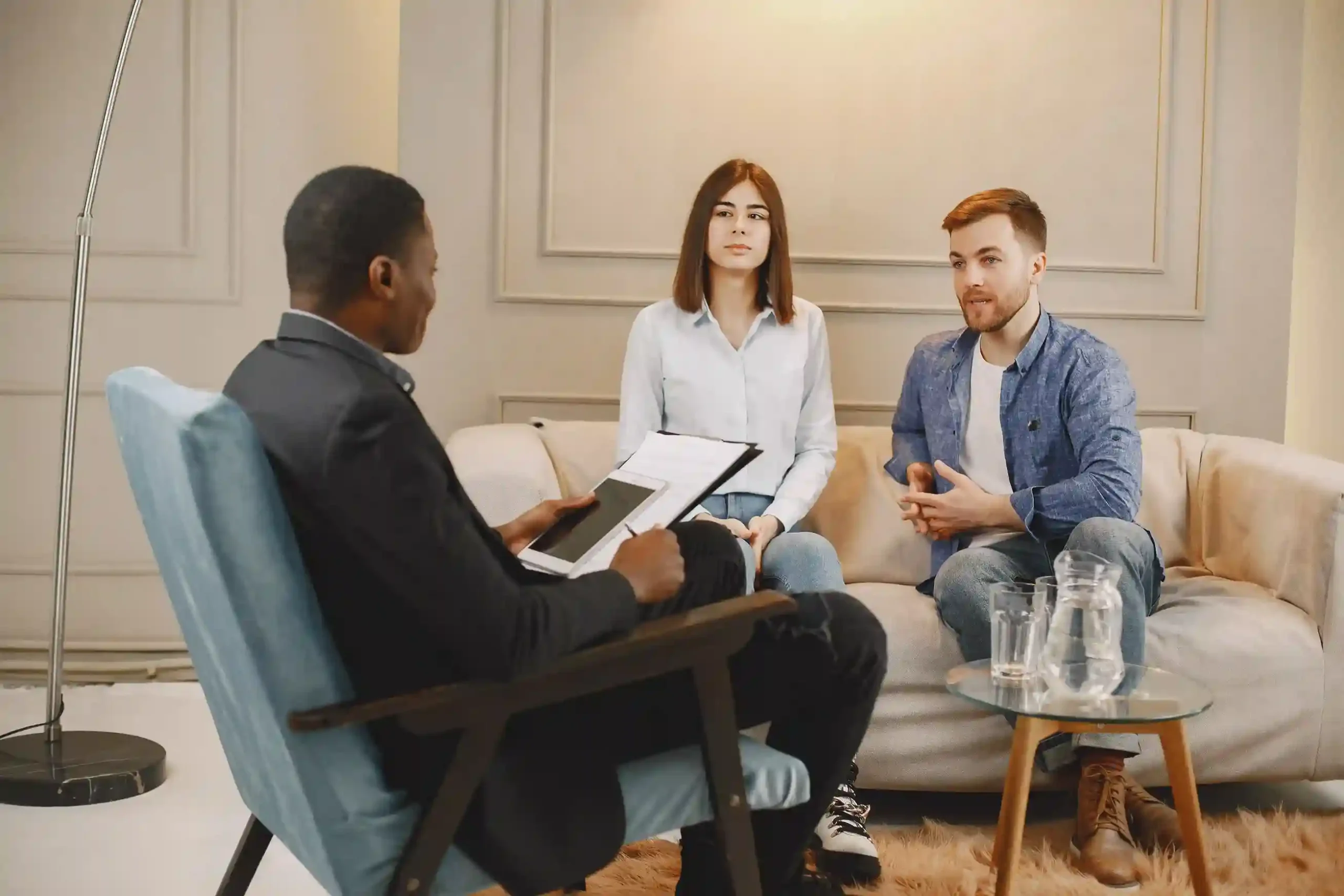 married couple discusses relationship challenges with a male psychologist during a couples therapy