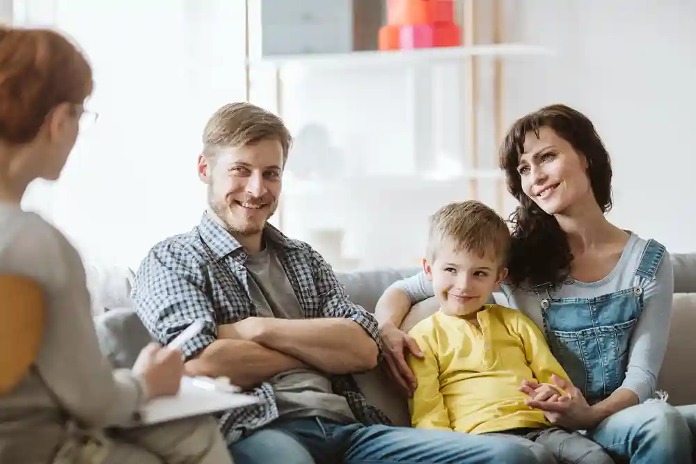 A mother and father with their young son attend a family therapy session in Tampa, FL