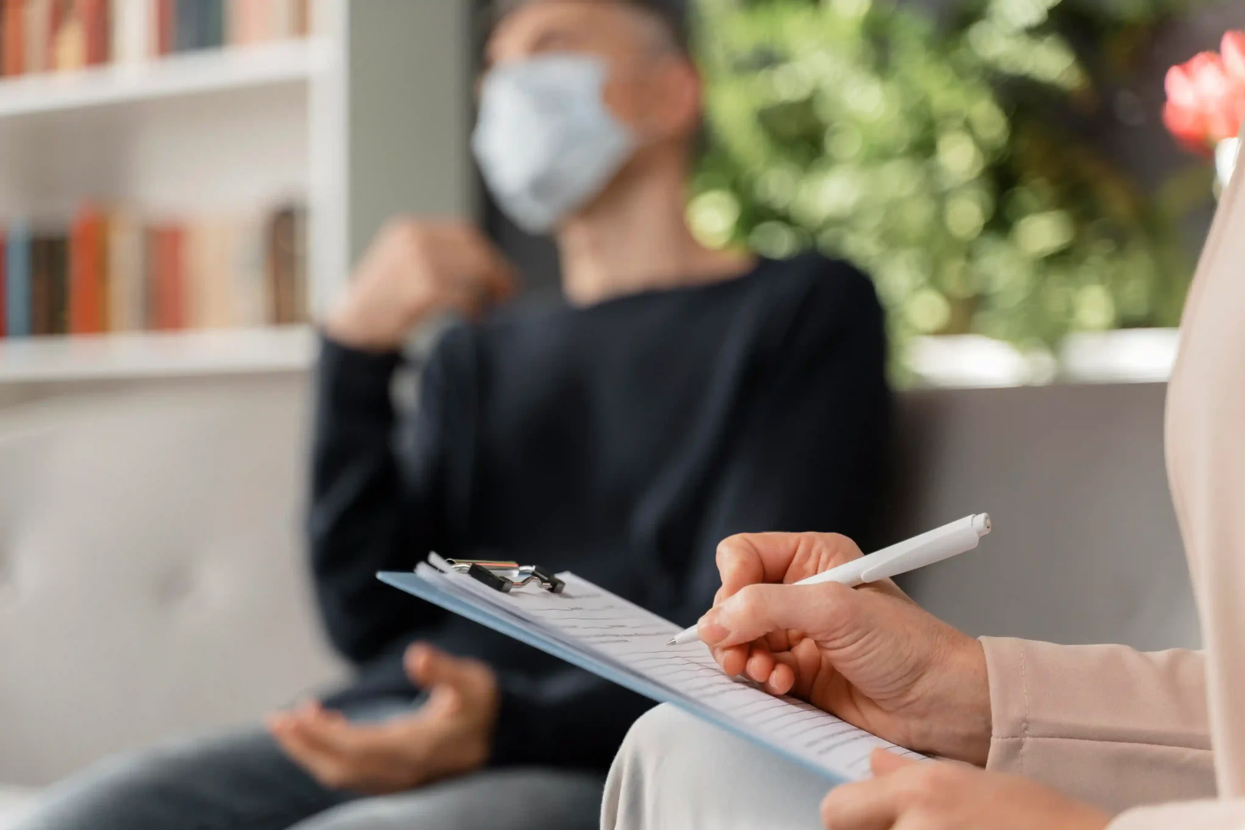 Close-up of a mental health professional conducting a psychological assessment with a patient