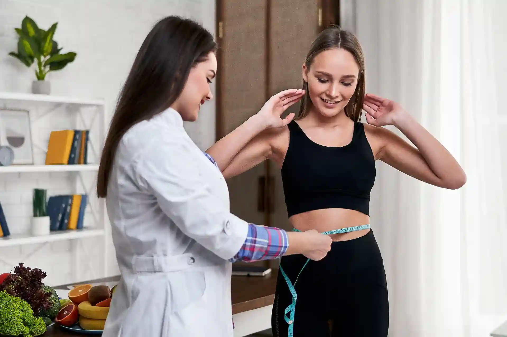 Nutritionist measuring a patient for a medical weight management program.