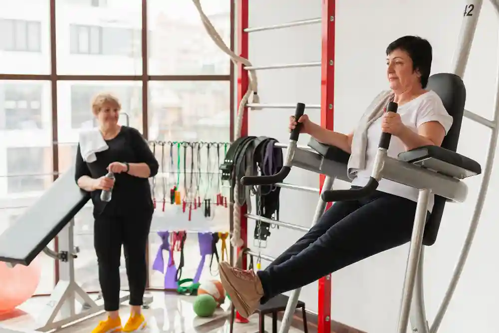 Women using gym equipment for leg strength training during weight loss program