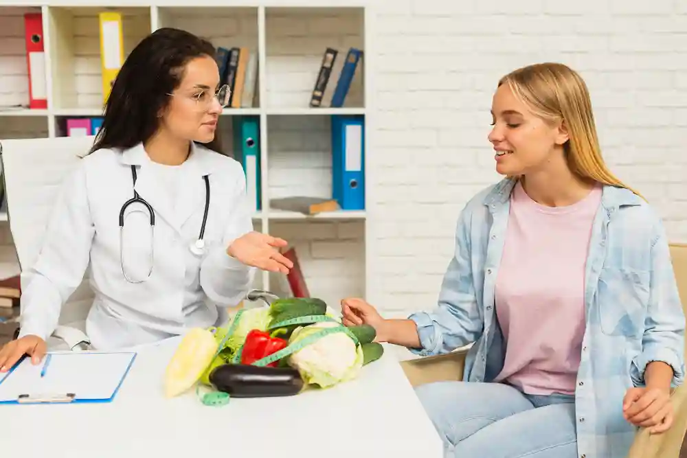 Doctor discussing nutrition and healthy eating with patient during consultation